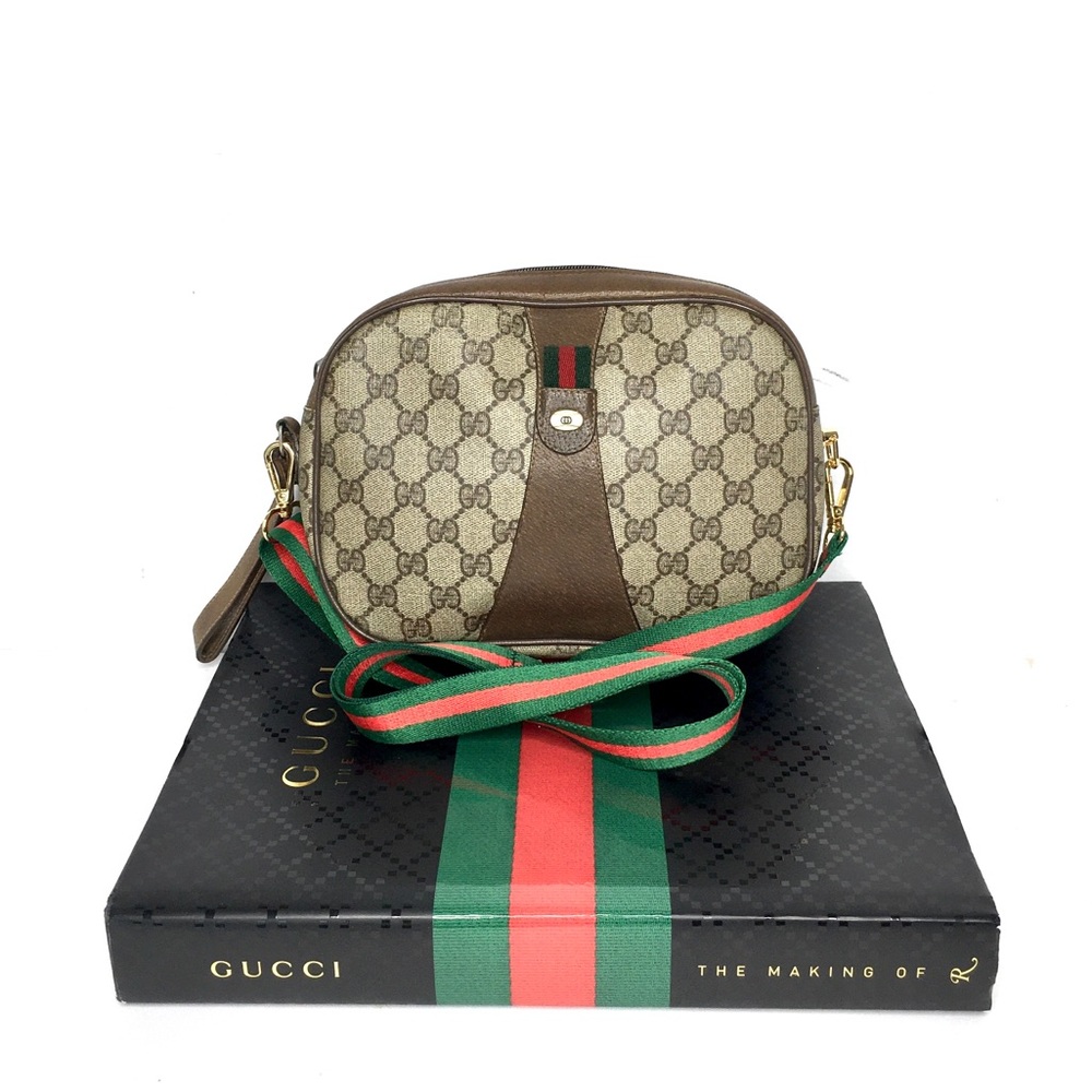 Authentic Gucci brown monogram coated canvas clutch strap included